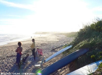 Surfers relaxing at Ditch Plains Beach after a great evening surf session